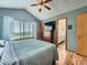 Bedroom with a scenic view, vaulted ceiling, and a television, connected to a modern bathroom at 3691 Bucknell Dr, Highlands Ranch, CO 80129