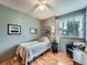 Cozy bedroom features a twin bed, wood floors, and natural light from a window at 3691 Bucknell Dr, Highlands Ranch, CO 80129