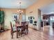 Bright dining room with wood floors, modern light fixture, and stylish decor at 3691 Bucknell Dr, Highlands Ranch, CO 80129