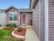 A welcoming front porch features colorful flowerbeds and a neatly maintained walkway at 3691 Bucknell Dr, Highlands Ranch, CO 80129