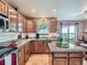Well-equipped kitchen with stainless steel appliances, granite countertops, and light wood cabinets at 3691 Bucknell Dr, Highlands Ranch, CO 80129