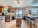 Bright kitchen with stainless steel appliances and sliding glass doors leading to outdoor patio at 3691 Bucknell Dr, Highlands Ranch, CO 80129