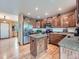 Spacious kitchen featuring an island with granite countertops and stainless steel appliances at 3691 Bucknell Dr, Highlands Ranch, CO 80129