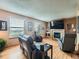 Inviting living room with a fireplace, two comfortable recliner chairs, and plenty of natural light at 3691 Bucknell Dr, Highlands Ranch, CO 80129