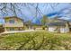 Spacious backyard with a patio area, lush lawn, and a storage shed at 4640 Fairplay Way, Denver, CO 80239