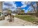 Landscaped backyard featuring a concrete patio with chairs and a storage shed at 4640 Fairplay Way, Denver, CO 80239