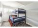 Shared bedroom with bunk beds, a window, and neutral paint, great for  at 4640 Fairplay Way, Denver, CO 80239
