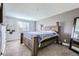 Spacious bedroom showcasing a large bed, plush carpet, and a bright window view at 4640 Fairplay Way, Denver, CO 80239