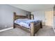 Neutral toned bedroom with a large bed, gray walls, and soft carpet flooring at 4640 Fairplay Way, Denver, CO 80239