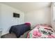 Bright bedroom with two twin beds, TV, and neutral walls, ideal for  at 4640 Fairplay Way, Denver, CO 80239