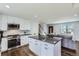 Spacious kitchen with an island, stainless steel appliances, and an open layout to the living area at 4640 Fairplay Way, Denver, CO 80239