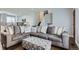 The open-concept living area flows from kitchen and features hardwood floors and lots of natural light at 4640 Fairplay Way, Denver, CO 80239