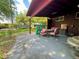 Relax on this covered brick back patio, perfect for outdoor dining and entertaining, complemented by a charming yard and mature trees at 10425 Franklin Way, Northglenn, CO 80233