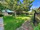 Beautiful back yard, featuring lush green lawn, mature trees, and a storage shed, perfect for outdoor activities and serene relaxation at 10425 Franklin Way, Northglenn, CO 80233