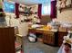 This basement area features unique wallpaper, two windows, and space for a desk and storage, perfect for a hobby or project room at 10425 Franklin Way, Northglenn, CO 80233