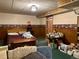 Cozy bedroom featuring wood paneling, floral wallpaper, and vintage décor at 10425 Franklin Way, Northglenn, CO 80233