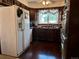 Vintage kitchen featuring wooden cabinets, retro appliances, and a window offering natural light at 10425 Franklin Way, Northglenn, CO 80233
