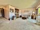 Cozy living room featuring plush carpeting, soft pink walls with floral accents, and vintage furnishings at 10425 Franklin Way, Northglenn, CO 80233