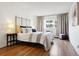 Bright bedroom with hardwood floors and large window at 3465 S Poplar St # 406, Denver, CO 80224