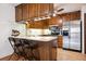Modern kitchen featuring stainless steel appliances and wood cabinets at 3465 S Poplar St # 406, Denver, CO 80224