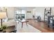 Bright living room featuring hardwood floors and access to a balcony at 3465 S Poplar St # 406, Denver, CO 80224