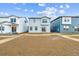 View of backyards between townhomes under sunny skies at 19038 E 94Th Pl, Commerce City, CO 80022