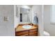 Bathroom vanity features an oval sink, warm wood cabinets, and a towel bar at 7865 S Lafayette Ct, Centennial, CO 80122