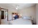 Relaxing bedroom with ample space, a ceiling fan, and a functional built-in desk area at 7865 S Lafayette Ct, Centennial, CO 80122