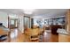 Open-concept dining area with hardwood floors, a wooden table, and an adjacent living room at 7865 S Lafayette Ct, Centennial, CO 80122