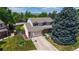 Charming two-story home featuring a well-manicured lawn, mature trees, and an attached two-car garage at 7865 S Lafayette Ct, Centennial, CO 80122
