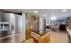 Well-lit kitchen with stainless steel appliances, hardwood floors, a center island, and ample storage at 7865 S Lafayette Ct, Centennial, CO 80122