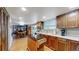 Bright kitchen with hardwood floors, a center island, and seamless transition to the dining and living areas at 7865 S Lafayette Ct, Centennial, CO 80122