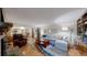 Spacious living room with hardwood floors, comfortable seating, and seamless flow to the dining area at 7865 S Lafayette Ct, Centennial, CO 80122