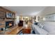 Cozy living room featuring a brick fireplace, hardwood floors, plush seating, and an open layout at 7865 S Lafayette Ct, Centennial, CO 80122