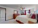 Comfortable main bedroom featuring a ceiling fan, natural light, and spacious closet space at 7865 S Lafayette Ct, Centennial, CO 80122