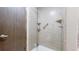 Bathroom shower features glass door and light stone-look surround at 7865 S Lafayette Ct, Centennial, CO 80122