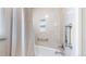 Elegant bathroom shower with beige tiles, a convenient built-in niche, and sleek chrome fixtures at 7865 S Lafayette Ct, Centennial, CO 80122