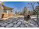Inviting backyard featuring a stone patio and a covered deck, ideal for relaxation and outdoor enjoyment at 18056 E Mansfield Ave, Aurora, CO 80013