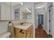 Bathroom with wooden vanity, sink, and ample lighting, offering a functional and aesthetically pleasing space at 18056 E Mansfield Ave, Aurora, CO 80013