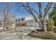 View of the side of a split level home showing siding and a two car garage at 18056 E Mansfield Ave, Aurora, CO 80013