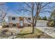 Split level home with brick and siding, landscaped front yard, and inviting walkway at 18056 E Mansfield Ave, Aurora, CO 80013
