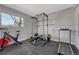 Home gym featuring exercise equipment, weights, and rubber flooring, perfect for fitness enthusiasts at 18056 E Mansfield Ave, Aurora, CO 80013