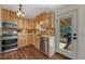 Bright kitchen featuring wood cabinets, stainless steel appliances, and backyard access at 18056 E Mansfield Ave, Aurora, CO 80013