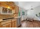 Convenient kitchenette area near the breakfast nook with wood cabinetry and stainless appliances at 18056 E Mansfield Ave, Aurora, CO 80013