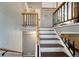 Interior staircase with painted risers and wood treads, plus decorative metal railing at 18056 E Mansfield Ave, Aurora, CO 80013