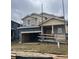 New construction with a front-facing two car garage, craftsman columns, and shingle siding at 7337 S Yank Ct, Littleton, CO 80127