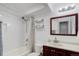 Clean bathroom with a shower, toilet, sink, vanity, and decorative shelves at 1585 S Holly St # 109, Denver, CO 80222