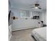 Bedroom with a large window, gray carpet, and ceiling fan at 1585 S Holly St # 109, Denver, CO 80222
