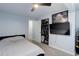 This bedroom features a ceiling fan, closet, and a wall-mounted television for entertainment at 1585 S Holly St # 109, Denver, CO 80222