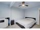 Bright bedroom with a ceiling fan, carpet flooring, and a bed at 1585 S Holly St # 109, Denver, CO 80222